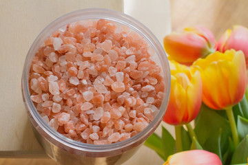 Fototapeta na wymiar Himalayan salt. Bath salt. Spa treatment. The concept of the beauty and relaxation Industry. Bath of crystals in a transparent jar. The view from the top. Space for text.