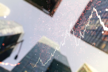 Double exposure of abstract financial chart with world map on office buildings background, research and analytics concept