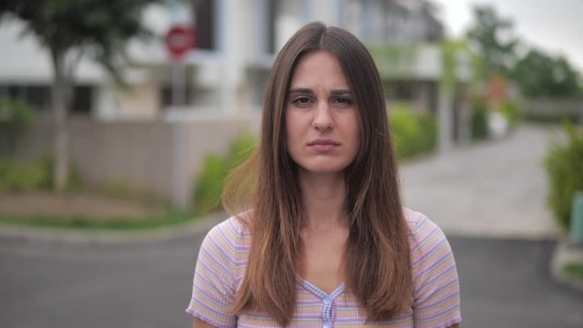 Portrait disappointment young woman feeling distaste isolated over urban background 4k