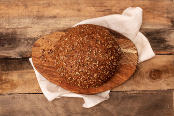 Freshly baked traditional bread on wooden table