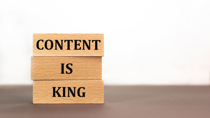 word content is king on wooden block on white background.
