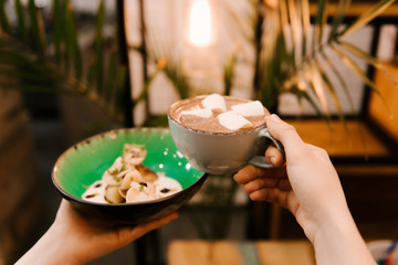 Small pancakes in a plate with berries and homemade sour cream with a Cup of cocoa with marmalade, desserts in the cafe, children's menu, selective focus