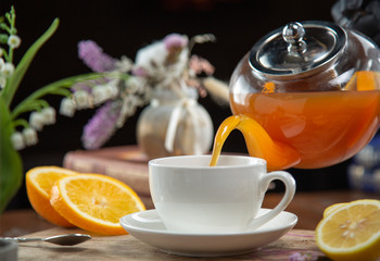 cup of tea with teapot and flowers
