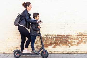 Mother and son riding an electric scooter