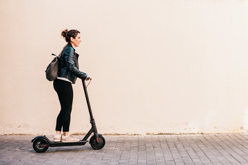 Middle aged woman riding an electric scooter © Victor