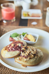 Breakfast table with food i the plate on the wooden table