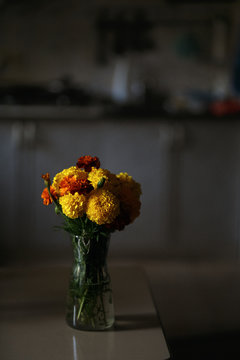 Bouquet Of Orange Flowers In A Vase On A Dark Background
