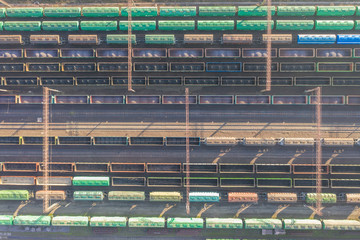 Many wagons are at the railway station. The contact network on the railway. View from above.