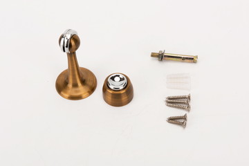 Various metal door stop tools on white background