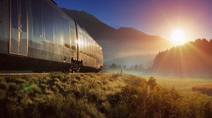 Railway and train in the Alpes at sunrise - obrazy, fototapety, plakaty