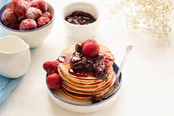 Pancakes for a week of Shrovetide with jam and fresh strawberries. Proper nutrition. Nutrition for vegetarians.
