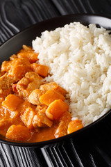 Domoda a delicious peanut stew is the national dish of Gambia close-up in a plate. vertical