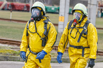Rescuer with protective suit exploring danger area. Biohazard, virus, chemical disaster