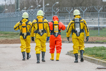 Rescuer with protective suit exploring danger area. Biohazard, virus, chemical disaster