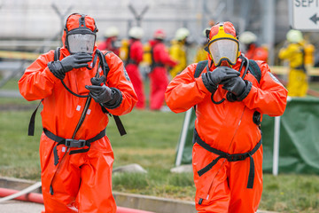 Rescuer with protective suit exploring danger area. Biohazard, virus, chemical disaster