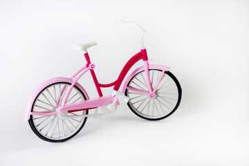 Fototapeta na wymiar pink bicycle with basket on a white background