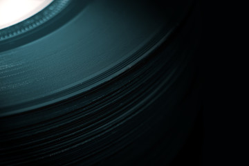 Vinyl records stacked on top of each other in a pile.  With colour toning