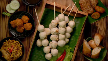 Cropped shot of Thai traditional street food with grilled meat balls on wooden tray
