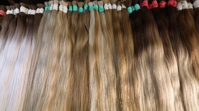 Natural female hair, beautiful female hair. Long hair extensions in the salon