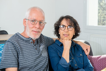 Senior couple relaxing on sofa at home