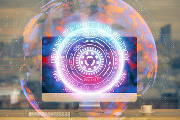 Computer on desktop in office with technology theme hologram. Multi exposure. Tech concept.