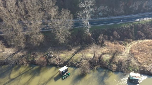 Dlying above raft on the river and road