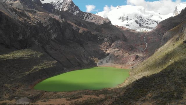 Amazing green lake in the peruvian andes, river from the glacier mountain, effects of meltdown, global warming.