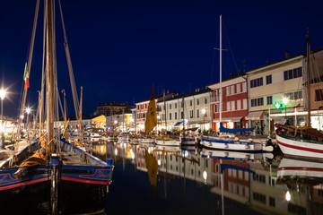 Night view of the port canal designed by Leonardo da Vinci and old town of Cesenatico on the...