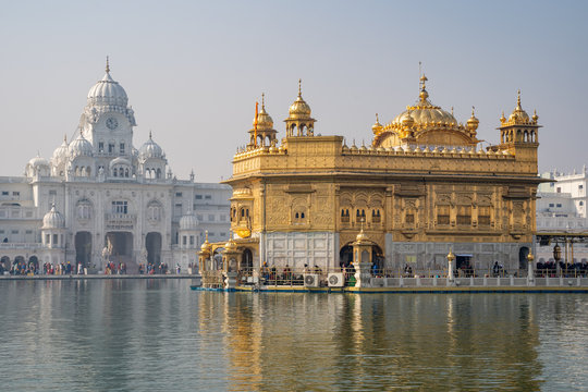 Amritsar India - The famous Sikh Golden Temple (sri harmandir sahib), as crowds make their way inside the building