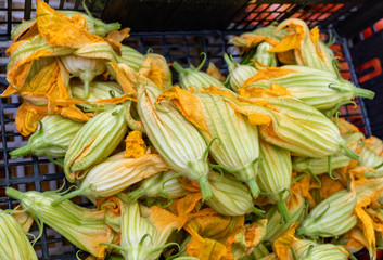 Fresh zucchini flowers at a farmers market in Italy