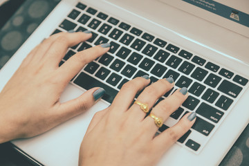 Women are working on a notebook.