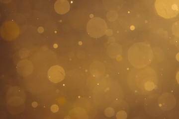 Dark Abstract Gold bokeh sparkle on black background