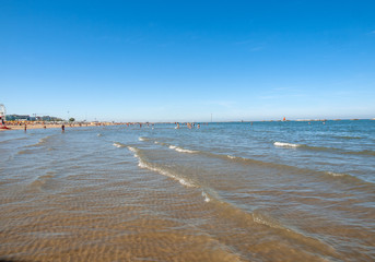 People are resting on a sunny day at the beach in Cesenatico, Italy
