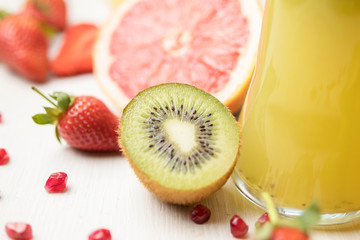 fresh fruit on a white table kiwi, Apple, strawberry, grapefruit, slices, bright juicy composition of healthy food