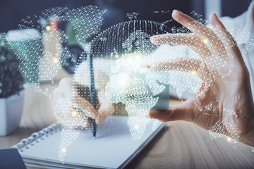 International business hologram over woman's hands taking notes background. Concept of success. Double exposure