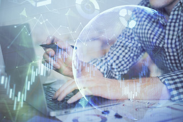 Double exposure of forex graph with man working on computer on background. Concept of market analysis.