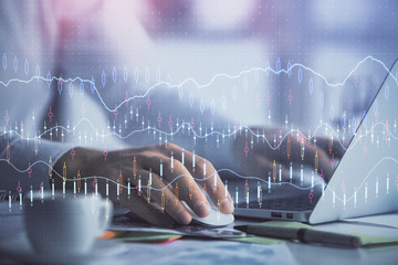 Double exposure of forex graph with man working on computer on background. Concept of market...