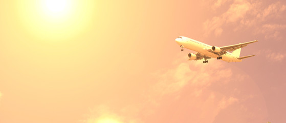 Passenger plane on the background of the sky with clouds and the sun is yellow shining.