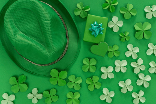 Saint Patrick's day background with hat, gift, heart and paper clovers