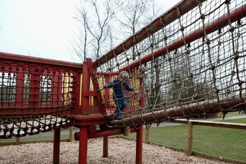 Fototapeta na wymiar Boy playing in a playground