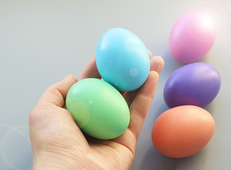 Multicolored colored Easter eggs in the palm of your hand. Selective focus. Easter eggs with beautiful highlights.