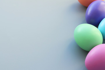 Easter colored eggs painted with bright colors on a gray background. Selective focus.Copy space