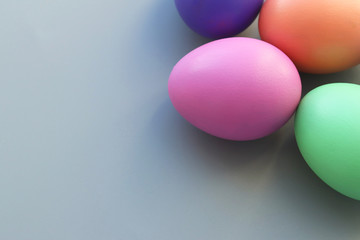Festive Easter background. Multicolored Easter eggs on a gray background. Selective focus. Copy space