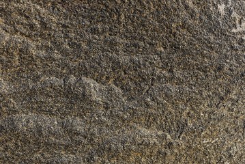 gray stone texture from a piece of granite wall in the foundation