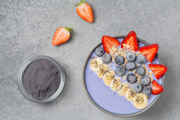 Healthy smoothie bowl with blue Matcha, berries, fruit, granola and Chia seeds. Delicious breakfast
