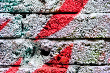 A crumbling brick wall as a texture painted silver color and red lines.