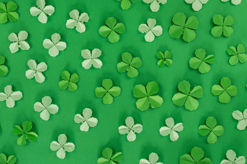 Saint Patrick's day background with origami clovers leaves.