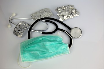 stethoscope and glasses on white background