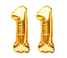 Number 11 eleven made of golden inflatable balloons isolated on white. Helium balloons, gold foil numbers. Party decoration, anniversary sign for holidays, celebration, birthday, carnival - obrazy, fototapety, plakaty
