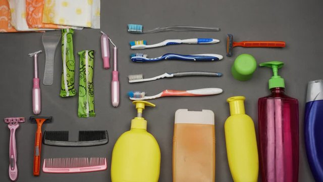 Bathroom plastic waste. Old used toothbrushes, disposable razor, synthetic washcloth, single-use sanitary pads, cotton buds, packaging of toothpaste, makeup, bottles of shampoo, liquid soap and shower